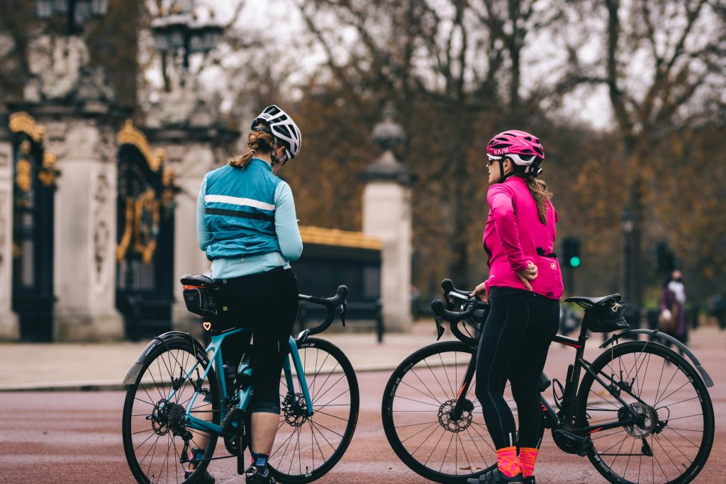 Deux femmes debout à côté de leurs vélos en ville